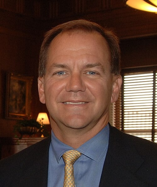 Paul Tudor Jones warns U.S. stock valuations at 252% of GDP could trigger a 30% to 35% correction, yet he is buying more AI stocks, betting on productivity gains lasting another two years or longer.